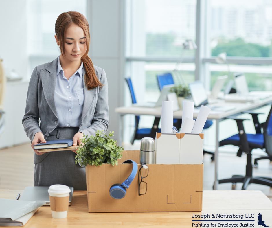 Woman packing up materials at desk