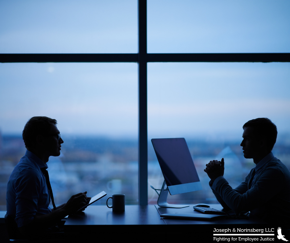 Two people conversing over a desk