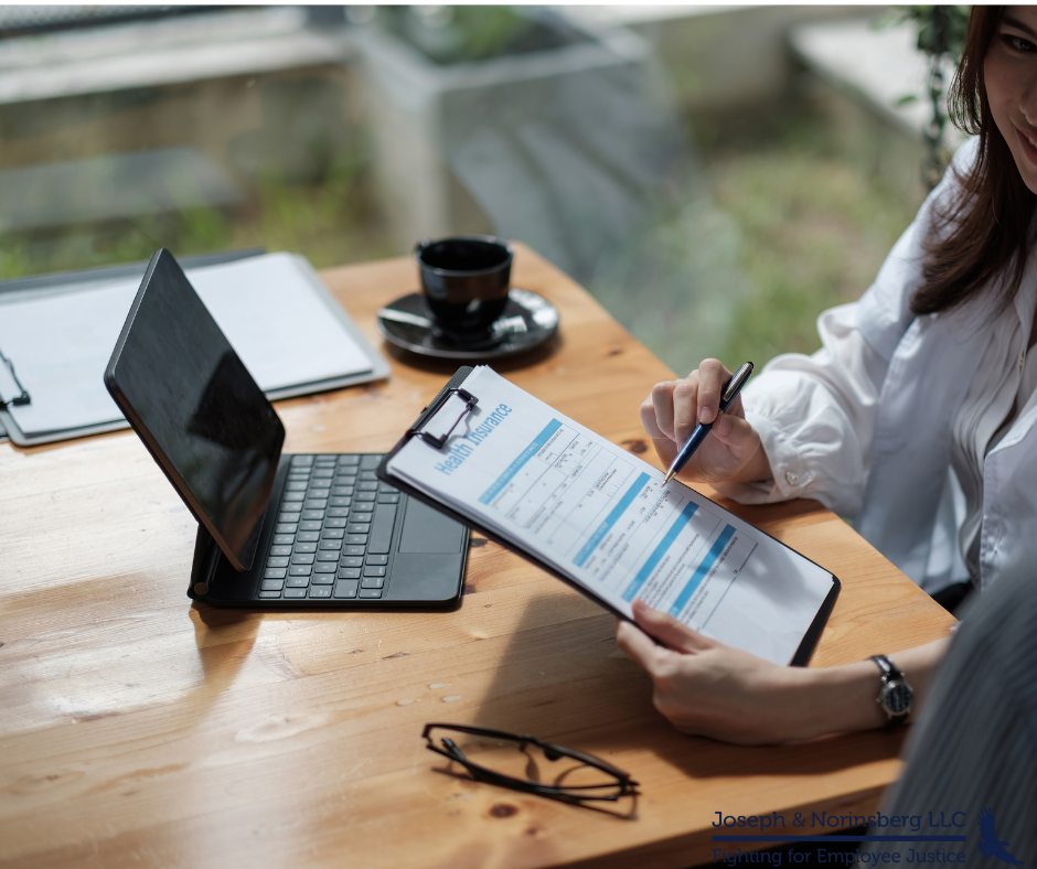 Two people looking over clipboard with paperwork