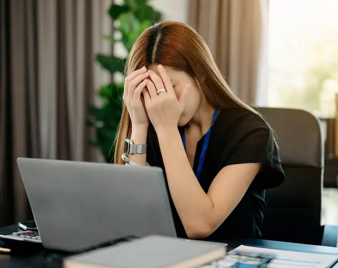 lady with hands over her face and upset
