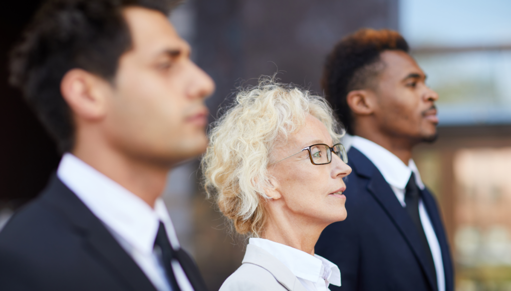 three-business-people-standing-and-looking-to-righ-2026-01-09-00-50-40-utc